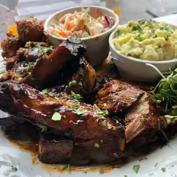 Po' Shines Cafe De La Soul's ribs with coleslaw, mashed potatoes, and hush puppies.